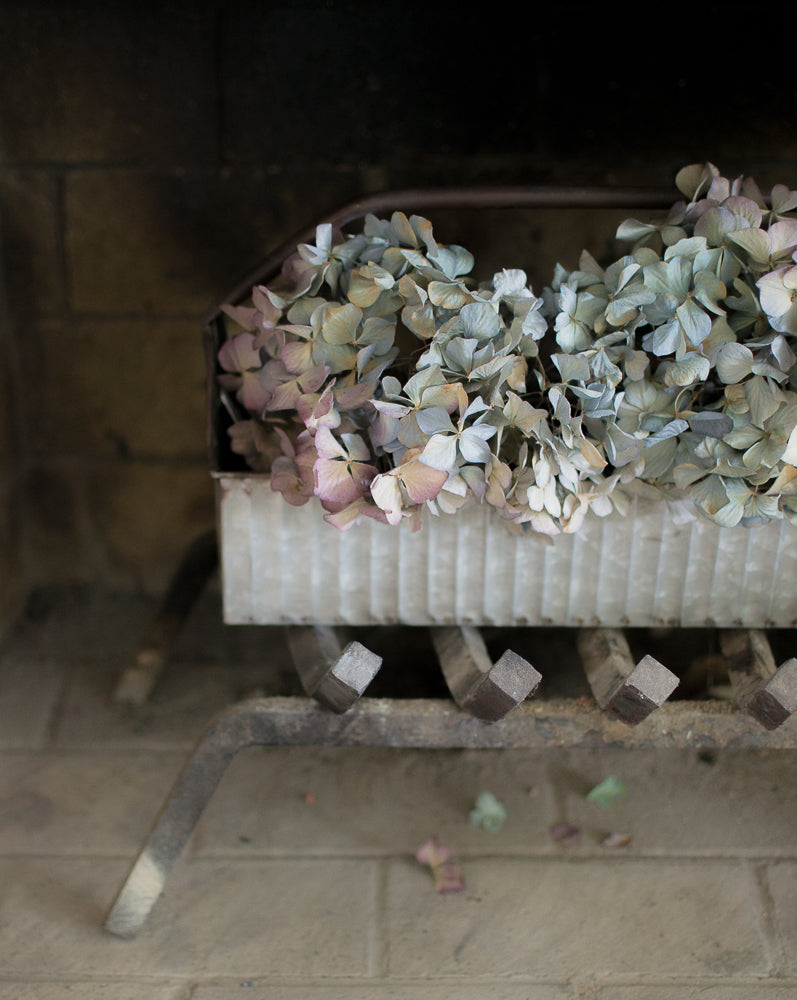 farmhouse style corrugated metal tool caddy with hydrangeas