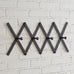 black metal accordian wall rack with hooks