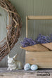 wooden tool caddy with lavender bundles and small bunny statue with ceramic robin eggs