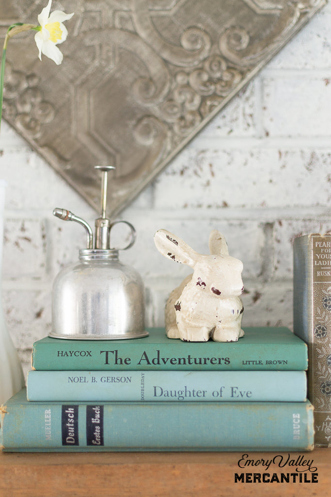 cast iron bunny statue painted white and distressed