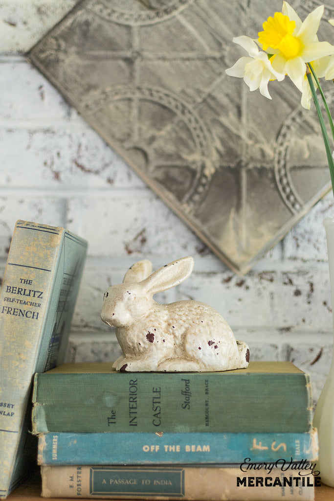 distressed white cast iron bunny statue