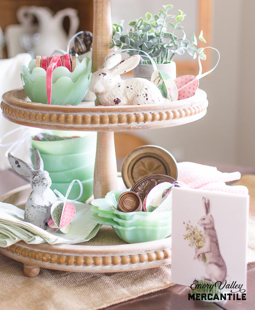 cast iron bunny figurine on wood tiered tray