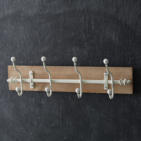 wooden wall rack with white hooks