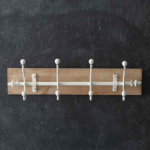 wooden wall rack with white hooks