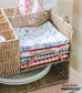 red white and blue napkins in wicker picnic caddy