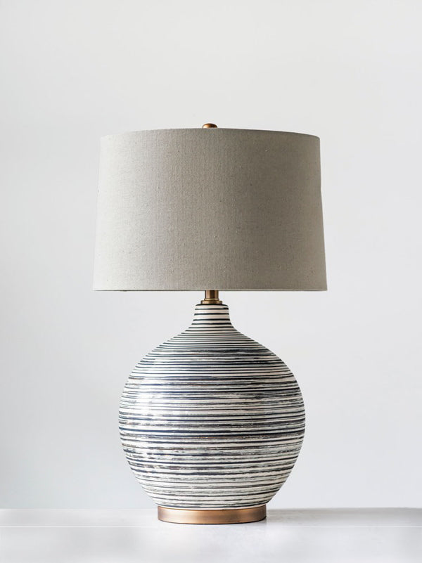 gray and cream striped ceramic lamp with natural linen shade
