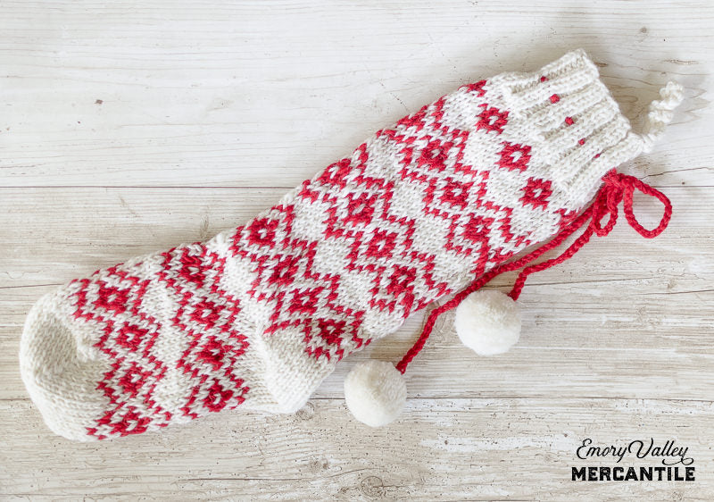 red and white scandinavian style knit wool stockings with pom tassles